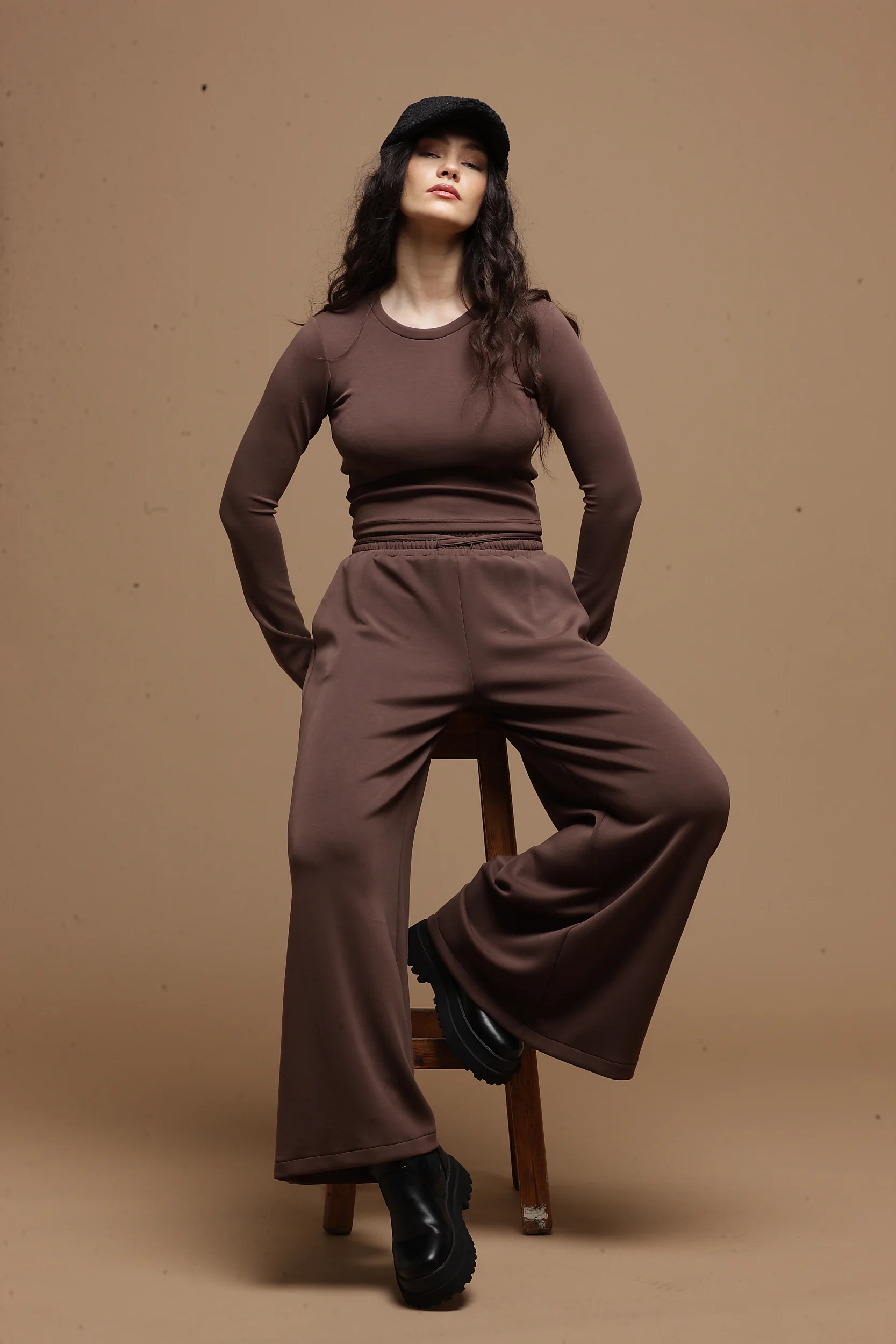 wide leg chocolate pants women Tag Modest Clothing Paullo Pants seated view