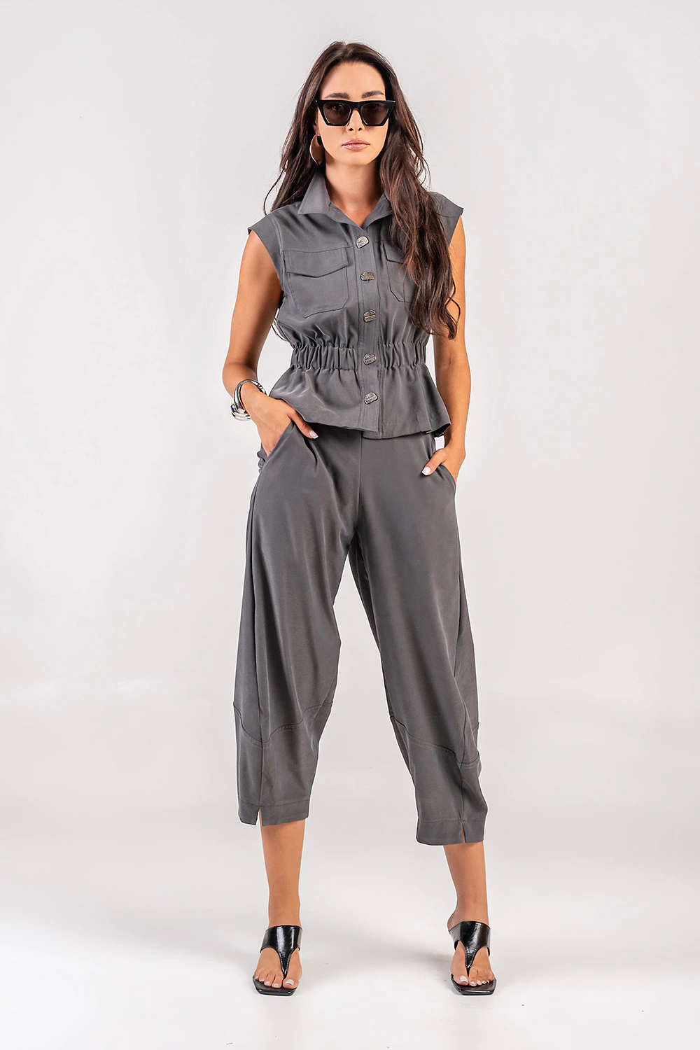 Teta Arvanitaki Avocado Grey Pants and Avocado Grey Shirt, full-length front view with hands in the trouser pockets