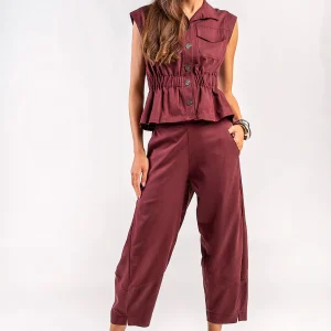 Teta Arvanitaki Avocado Wine Pants and Avocado Wine Shirt, front view showing the curved trouser legs and sleeveless button-front shirt
