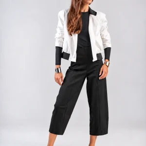 Teta Arvanitaki Character White Jacket, front view showing the contrasting black collar and hem details, styled with black cropped trousers