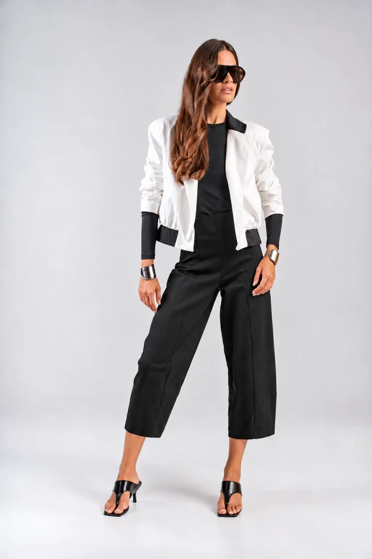 Teta Arvanitaki Character White Jacket, front view showing the contrasting black collar and hem details, styled with black cropped trousers