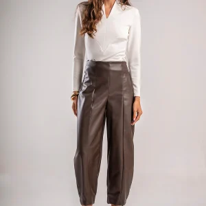 Teta Arvanitaki Ginger White Blouse, front view with arms raised showing the long sleeves and geometric seam detail