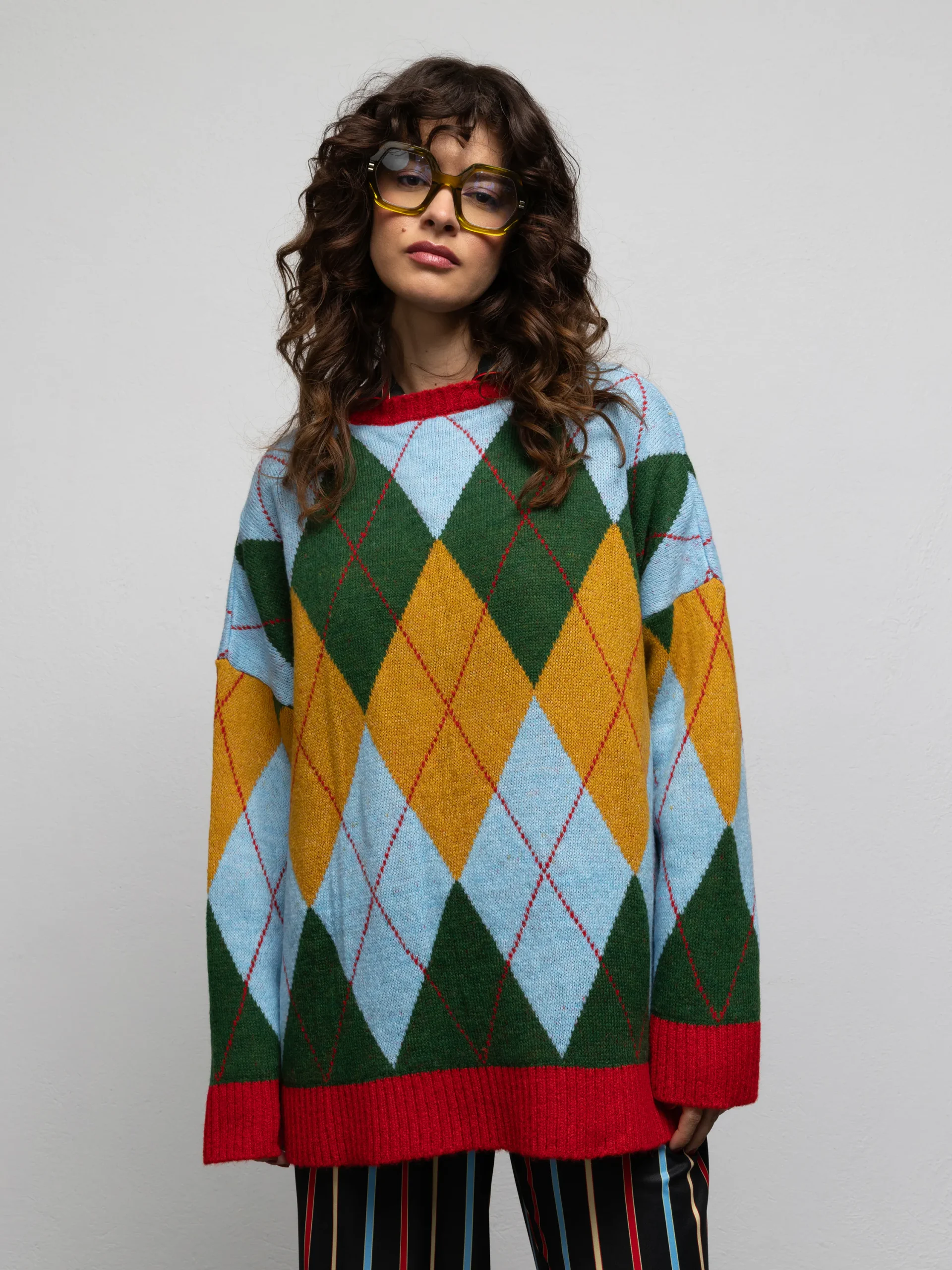 Warhol Diamond Green sweater by We Are, close-up front view showing the round neckline and red ribbed cuffs and hem