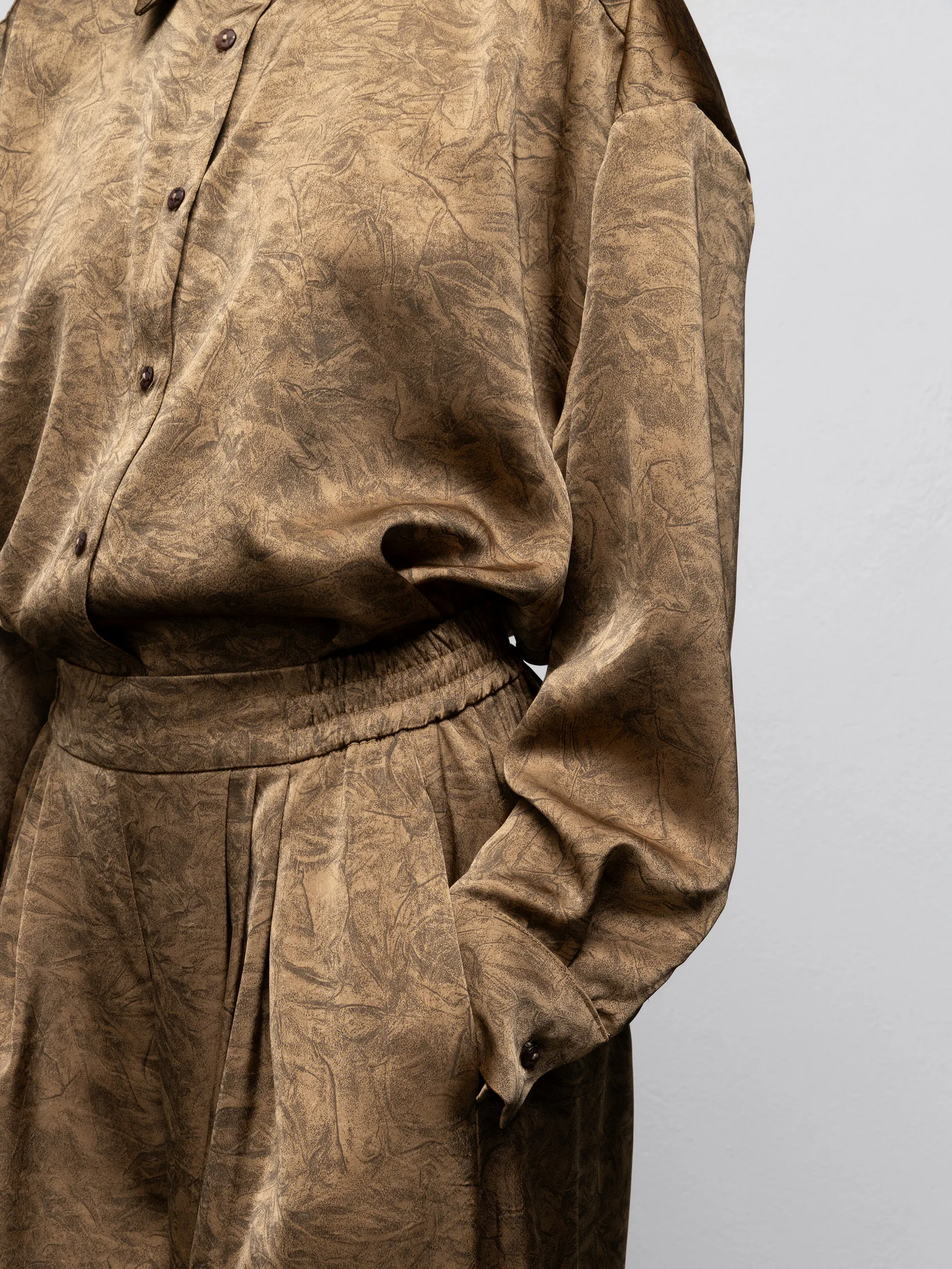 we are doris pants vintage gold waistband pleats and tonal print detail
