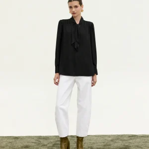 Innocent Estelle Tie-Neck Top in black on model, front view showing neck tie and gathered shoulders