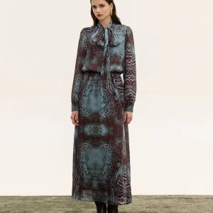 Innocent Isolde Tie-Neck Dress on model, front view showing mixed animal print, neck tie and waist belt