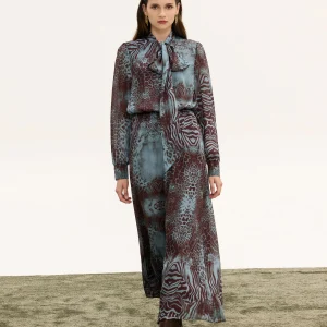 Innocent Isolde Tie-Neck Dress on model walking, front view showing animal print and long skirt