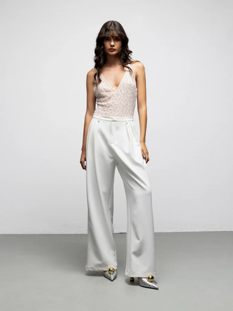 White high-waisted Jagger pants by We Are with front pleats and wide legs, front view